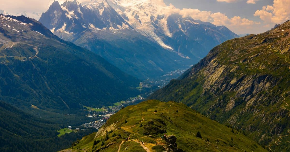 Wanderer auf einem alpinen Steig, im Hintergrund vergletschertes Hochgebirge